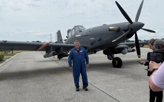 L3Harris test pilot Clint Logwood stands in front of a Sky Warden aircraft brought in to display at SOF Week. (MES staff photo)