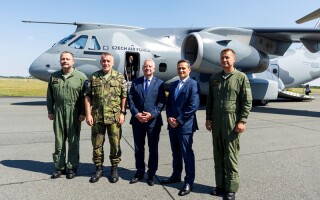 Officials post in front of C-390 (via Embraer)