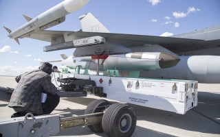 A weapons load team prepares to remove a Joint Strike Missile from a 416th Flight Test Squadron F-16 Fighting Falcon .U.S. Air Force photo by Christopher Okula.